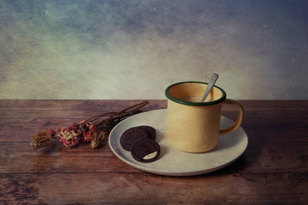 picture of milk mug with oreo cracker on the wooden table on vintage backgroundの写真素材