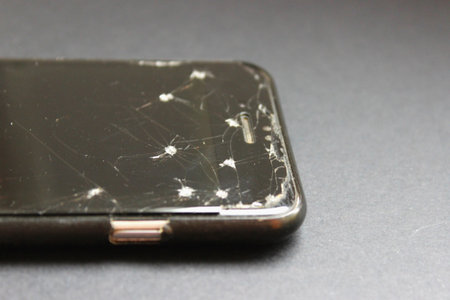 Cracked smartphone screen corner close-up