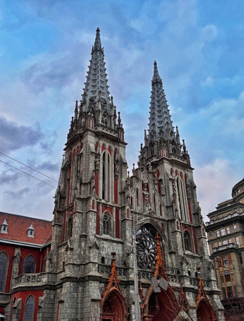 Front view of St. Nicholas Roman Catholic Cathedral in Kyiv, Ukraine, twin spires and gothic revival facade under cloudy evening sky, editorial city landmark.の写真素材