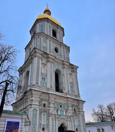 Close view of Saint Sophia Bell Tower with golden dome in Kyiv, Ukraine. Baroque facade, pastel ornament, winter daylight, vertical exterior composition.の写真素材