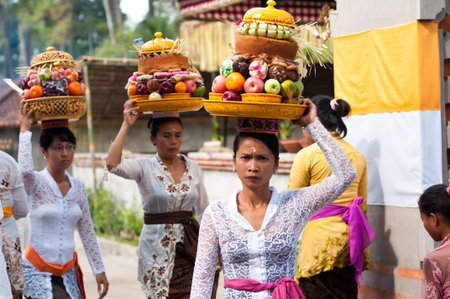 Tirta Empul, Bali, Indonesia - October 11, 2011  woman with basket on here head walking to Tirta Empul Temple to give offerings to the spiritsのeditorial素材
