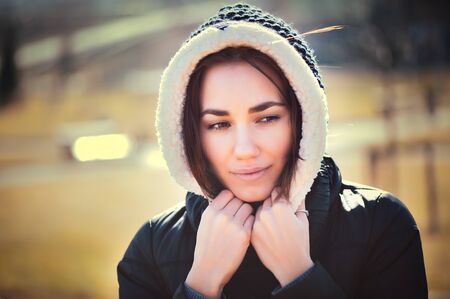 Spring outdoor closeup portrait of young thoughtful woman.の写真素材