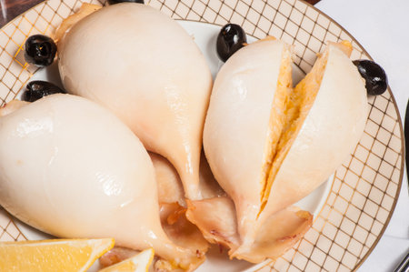 Squids stuffed with cheese and shrimps on a gilded plate