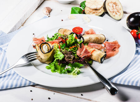 Salad with eggplant rolls, cheese, bacon and lettuce leavesの写真素材