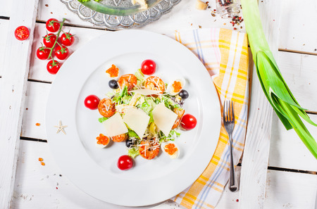 Salad with quail eggs, red caviar, cheese, olives and big shrimpsの写真素材