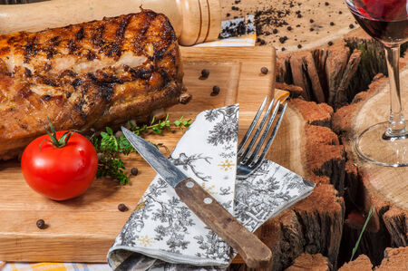Grilled lamb on wooden board with red wineの写真素材