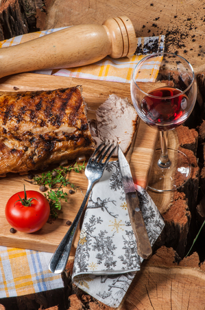 Grilled lamb on wooden board with red wineの写真素材