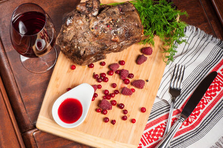 Big piece of fried lamb with sweet berry sauceの写真素材