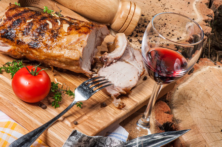 Grilled lamb on wooden board with red wineの写真素材