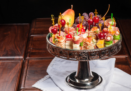 Various kinds of canapes with cheese, meat, fish, fruits and vegetablesの写真素材