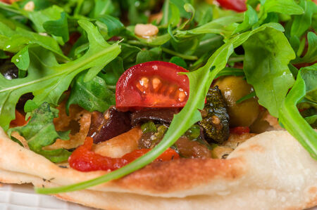 Focaccia with grilled vegetables and arugula on big plateの写真素材