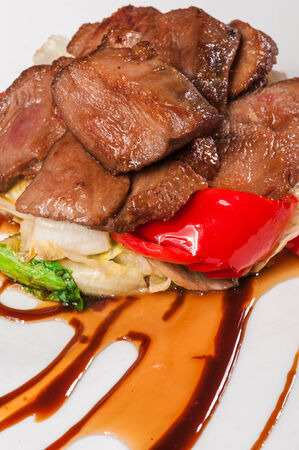 Beef goulash with different vegetables on white plateの写真素材