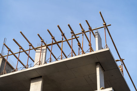 Construction of a new residential monolithic-frame house in the city using a truck crane in clear...