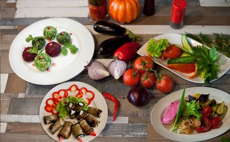 non-cuts and snacks on a wooden table with vegetablesの写真素材