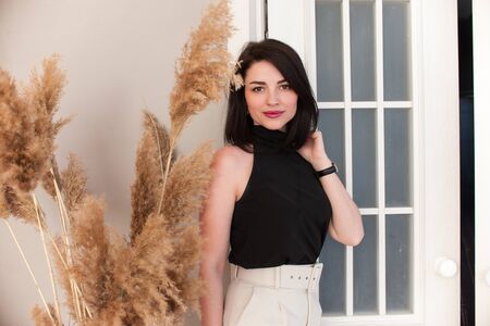 young girl, half-length portrait, standing against the background of bright walls and smilingの写真素材