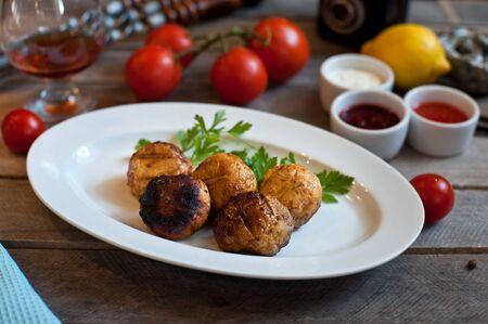 grilled mushrooms on a white plate. Wooden backgroundの写真素材