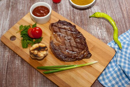 steak with vegetables on a wooden backgroundの写真素材
