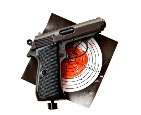 gun with dartboard with hole from shotの写真素材