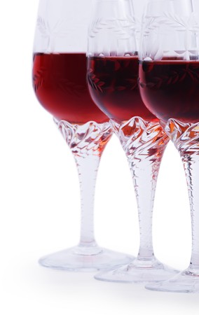 Three glasses of red wine isolated on a white background Focus is on the third glass. Hand made clipping path insideの写真素材