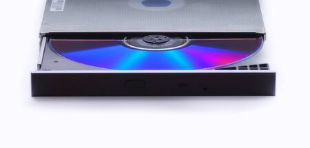 Ejecting or Inserting  cd, dvd or blueray disk into drive  without a computer. Isolated on a white backgroundの写真素材