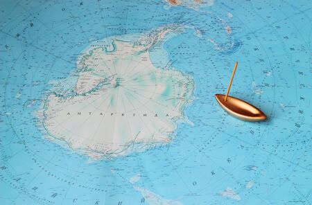 Strange map of Antarctica and boat at coastの写真素材