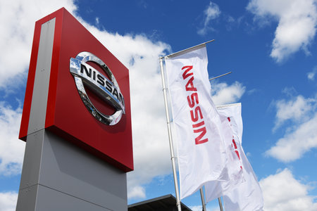 Celle, Lower Saxony, Germany - June 8, 2019: dealership sign of Nissan against blue sky in Celle, Germany - Nissan is a Japanese multinational automakerのeditorial素材