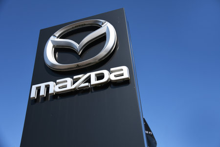 Hannover, Lower Saxony, Germany - April 5, 2020: Dealership sign of Mazda against blue sky in Hanover, Germany - Mazda is a Japanese multinational automakerのeditorial素材