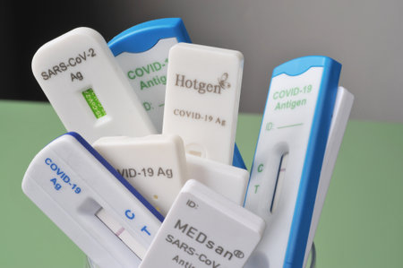 Burgdorf, Lower Saxyony, Germany - February 9, 2022: A large amount of different covid-19 antigen rapid tests with negative test resultsのeditorial素材