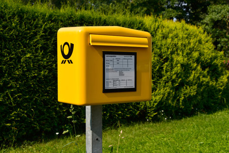 Grossmoor, Lower Saxony, Germany - July 27, 2012: Yellow Mailbox of Deutsche Post AG, the world's largest postal service - Grossmoor, Germanyのeditorial素材
