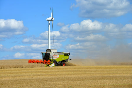 Soltau, Lower Saxony, Germany - August 19, 2016: Combine Harvester in action on wheat field under...