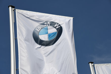 Munich, Bavaria, Germany - May 19, 2018: Flags in front of Headquarters of BMW AG in Munich, Germany - BMW is a German multinational company which produces automobiles and motorcyclesのeditorial素材