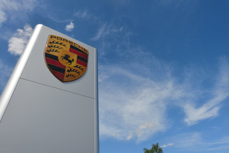 Bayreuth, Bavaria, Germany - May 20, 2018: Dealership sign of Porsche against blue sky in Bayreuth, Germany - Porsche is a German automobile manufacturer specialized in high-performance sports carsのeditorial素材