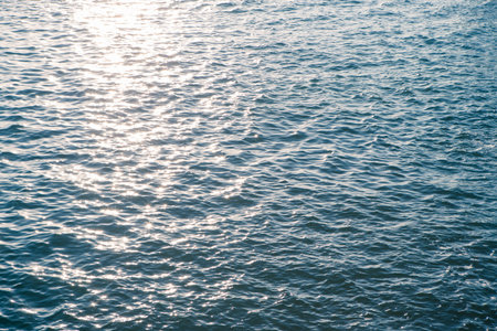 Sea water surface with sparkling sun light in evening