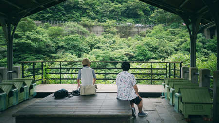 Back view of two men traveling in Taiwan.の写真素材