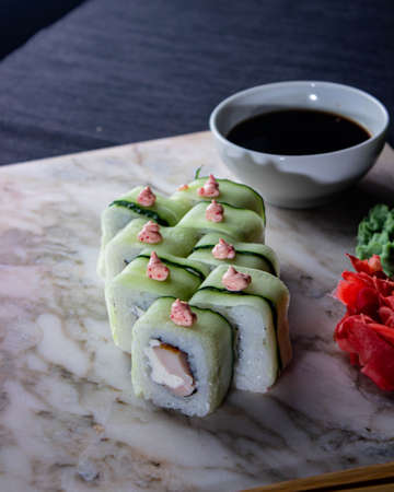 Sushi. A serving of fresh Japanese rolls on a marble board with soy sauce, wasabi and pickled ginger.の写真素材