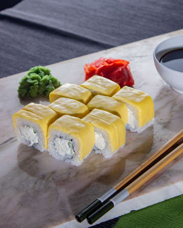 Sushi. A serving of fresh Japanese rolls on a marble board with soy sauce, wasabi and pickled ginger.の写真素材