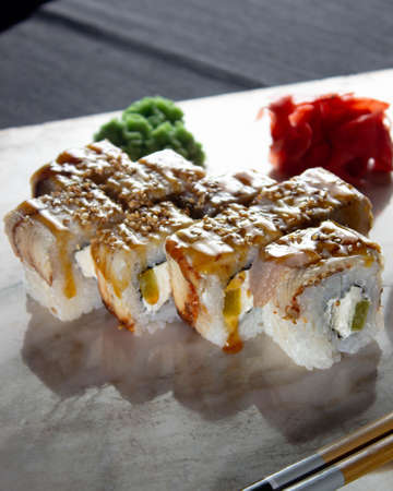 Sushi. A serving of fresh Japanese rolls on a marble board with soy sauce, wasabi and pickled ginger.の写真素材