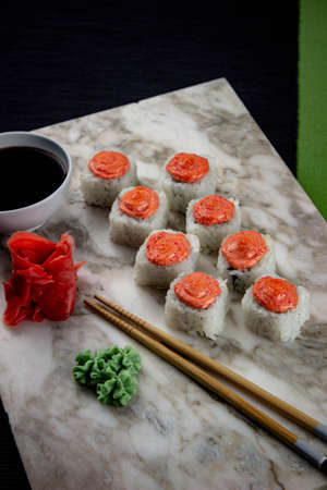 Sushi. A serving of fresh Japanese rolls on a marble board with soy sauce, wasabi and pickled ginger.の写真素材