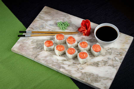 Sushi. A serving of fresh Japanese rolls on a marble board with soy sauce, wasabi and pickled ginger.の写真素材