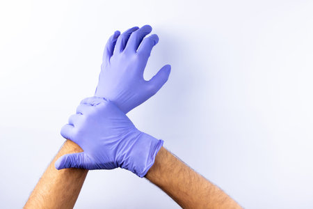 two human hands in blue nitrile surgical gloves, professional medical safety and hygiene for surgery...