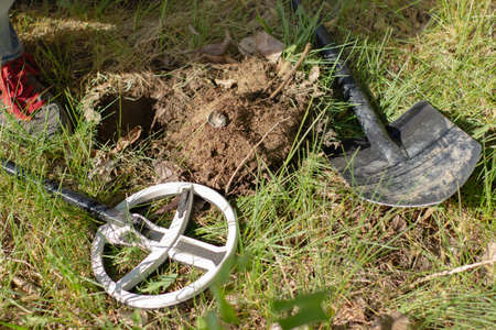 a metal cork from a bottle found with a wireless metal detector on a background of grassの写真素材