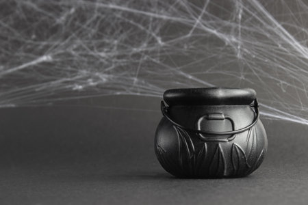 fake witch's cauldron, on a black background with cobwebs.  halloween conceptの写真素材