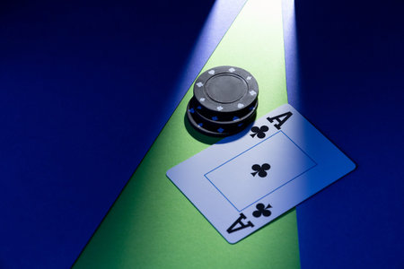 A plastic playing card lies on a blue-green background, next to three chips.