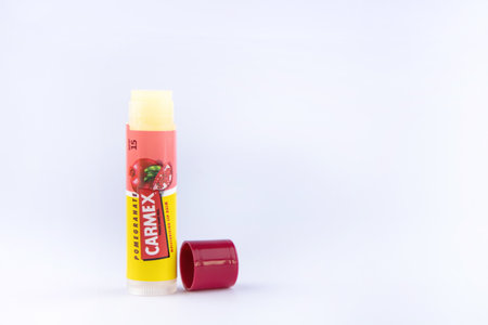 Carmex brand healing lip balm with pomegranate flavor. Standing on a white backgroundのeditorial素材