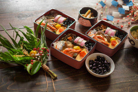 Japanese food in containers on a wooden table, close-up.の写真素材