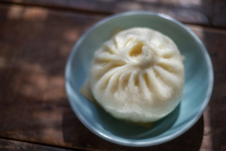 steamed dumpling - chinese bun on wooden background.の写真素材