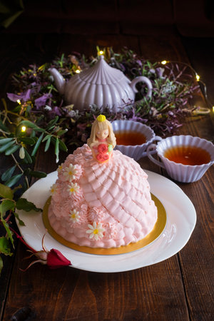 Easter cake decorated with Easter bunny and flowers on a wooden backgroundの写真素材