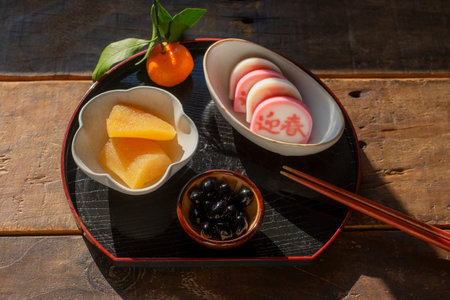 Japanese confectionery, omelet and tangerine on plateの写真素材
