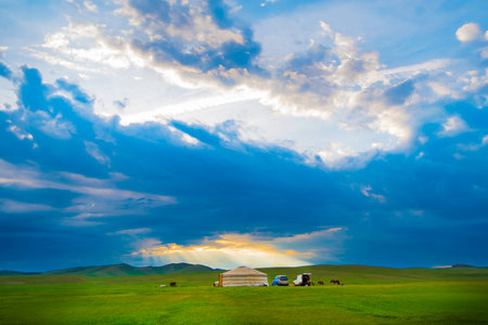 Mongolian grassland in the evening with blue sky and clouds