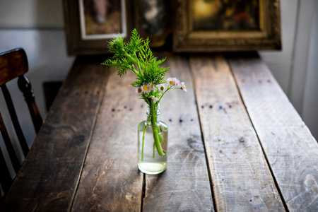 Bouquet of wildflowers in a vase on a wooden tableの写真素材